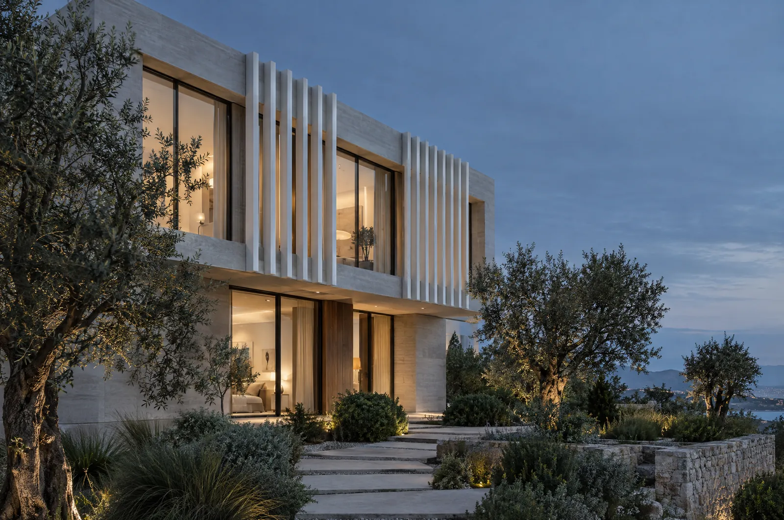 Contemporary residence with vertical fins and warm interior light at dusk